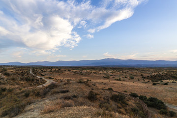Fototapeta na wymiar adventure steppe landscape with blue sky and clouds