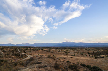 steppe desert landscape with blue sky and clouds
