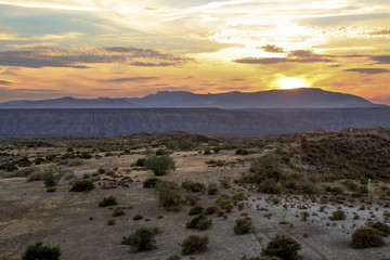 sunset over the mountains of a steppe grassland landscape