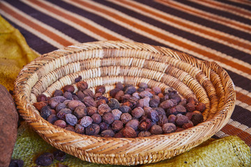 Raw argan nuts in a traditional moroccan bowl ready for preparing argan oil