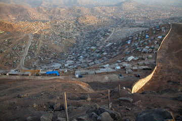 View of the large slum of San Juan de Miraflores right on the edge of the big city of Lima, Peru.