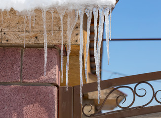 Icicles on vintage roof closeup. Winter weather concept. Froze and ice background. Christmas weather concept. Snow and icicle. Melting icicles. Long sharp icicles. Frozen water. Cold weather concept