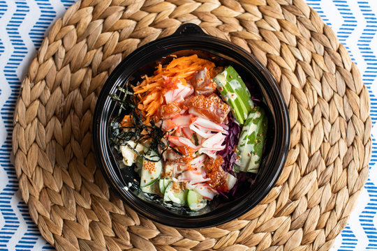 Hawaii Poke Bowl With Salmon, Rice, Surimi, Avocado, Tobiko, Carrot And Seaweed