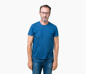 Handsome middle age hoary senior man wearin glasses over isolated background Relaxed with serious expression on face. Simple and natural looking at the camera.