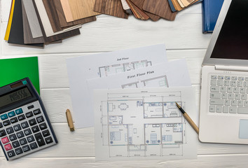 Top view on house plan and laptop with calculator