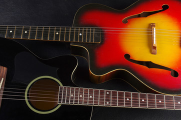 Fototapeta na wymiar Two acoustic guitars on a dark background