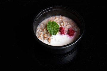 oatmeal porridge with curds and raspberry in eco food container