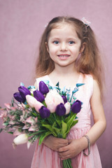 happy womens day for my mom, little girl holds flowers tulip