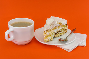 Cup of coffee with piece of tasty cake