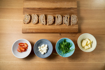 Small party sanwiches on wooden board on wooden table witch ingredients in colorful bowls Happy Sandwiches Part 2 from 9