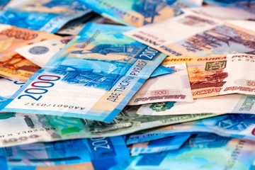 Fototapeta na wymiar Russian cash money 5000, 2000, 1000, 500 lying on plane. Rubles banknote as background, closeup