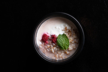 ready meal to eat for breakfast, porridge into black food box with berries