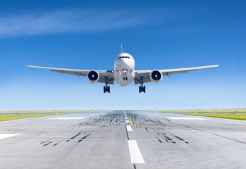 Fototapeta na wymiar Landing airplane exactly on the runway airport