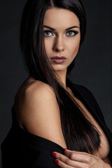 Sensual brunette lady portrait on black background