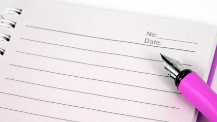 A Notepad with a pen on a white background