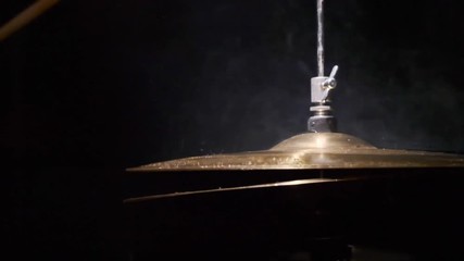 Drummer hitting on wet drum cymbal, and the water splashing from cymbal in slow motion. - Powered by Adobe