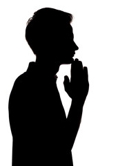 Obraz na płótnie Canvas black and white silhouette portrait of an unrecognizable man with his hand on his chin thinking, guy face profile on a white isolated background,concept teenager problem and emotional stress