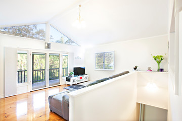 Open plan living room with upstairs balcony