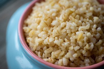 Boiled bulgur in a pot, vegetarian food.