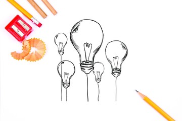 pencils, a red sharpener and sketched lightbulbs