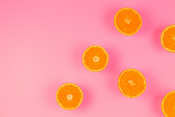 Fresh orange slices on pink background, top view