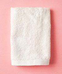 White spa towel on pink,from above