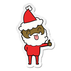man with beard sticking out tongue wearing santa hat
