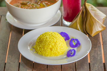 Turmeric Rice and Butterfly pea on white plate.