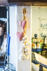 Garlic and textil heart decorations in the kitchen
