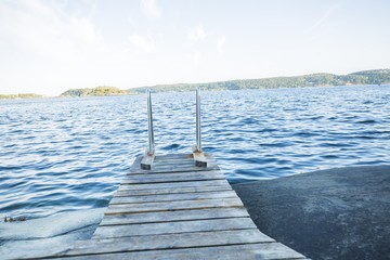 Fototapeta na wymiar wooden pier on the deep blue water