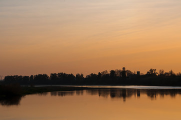 Sunset over the river and trees