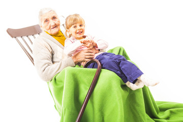 Old woman sitting on the chair with grandchildren