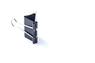 Stationery black paper clip on white background, isolate