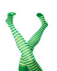 Funny female legs in green striped stockings. Leprechaun girl, isolated on white