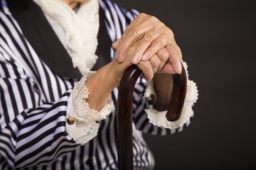 Old grandma in a white-black striped jacket
