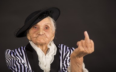 Old grandma in a white-black striped jacket - obrazy, fototapety, plakaty