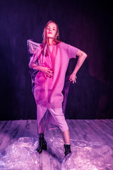 Cute longhaired model covering herself with plastic