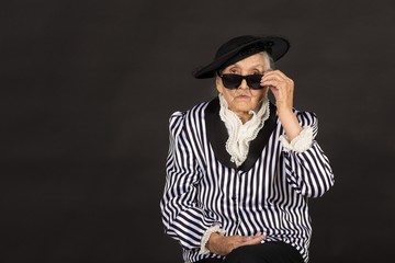 Old grandma in a white-black striped jacket