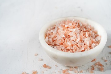 Himalayan pink salt background, selective focus