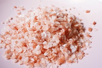 Himalayan pink salt background, selective focus