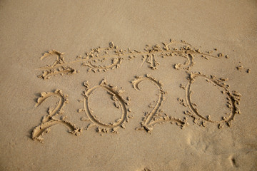 Fototapeta na wymiar 2020 Year written on the beach sand