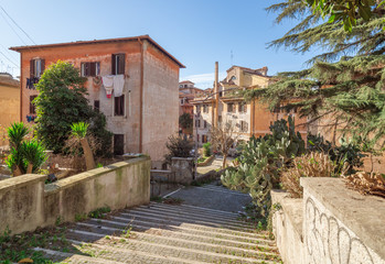 Rome (Italy) - The suggestive popular Garbatella quarter in Ostiense district, an agglomeration in Rococo style with gardens and the famous modern bridge named Settimia Spizzichino