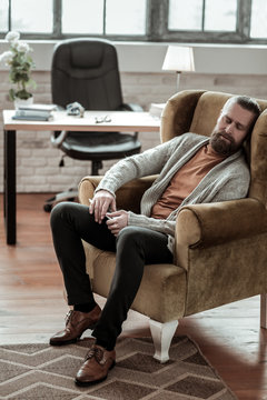 Bearded Counselor Wearing Grey Cardigan Falling Asleep