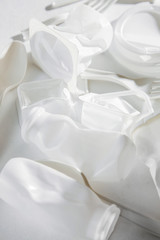 White single use plastic on  white background. Closeup. .Concept of Recycling plastic and ecology. Flat lay, top view
