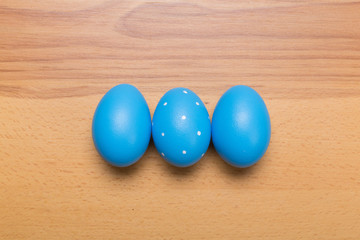 blue Easter eggs on wooden background
