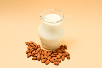 A jar with almond milk, nuts. Space for text or design.