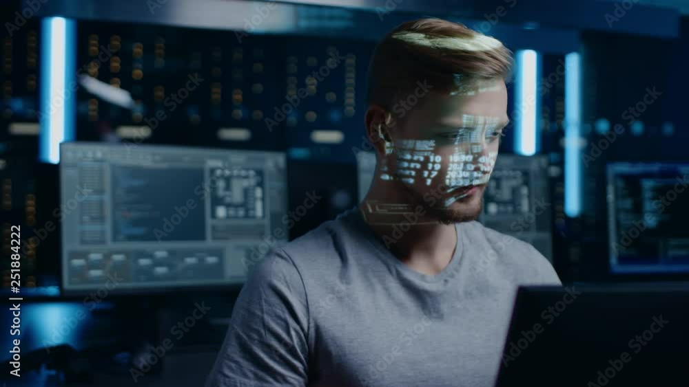 Fototapete Portrait of Young Software Developer Working on Computer in Digital Identity Cyber Security Data Center, Projected Program Coding Language Reflects on Face. Futuristic Hacking and Programming Concept