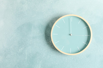 Big beautiful clock hanging on color background, space for text
