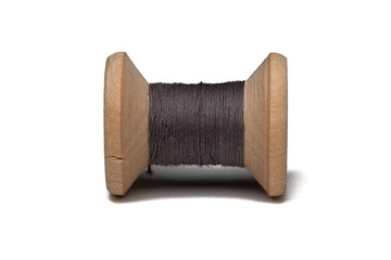 Wooden coil with thread on a white isolated background
