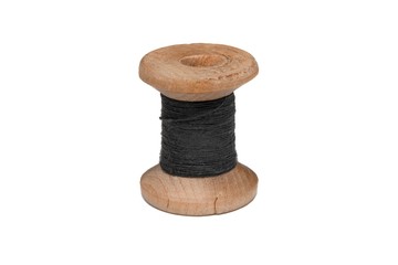 Wooden coil with thread on a white isolated background